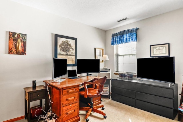 office featuring visible vents, carpet, and a textured ceiling