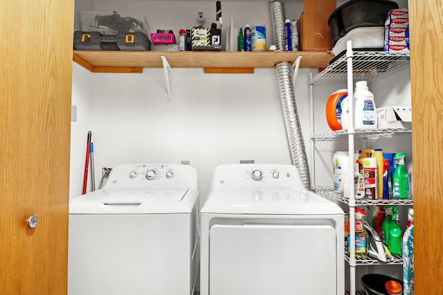 laundry area with washing machine and clothes dryer and laundry area