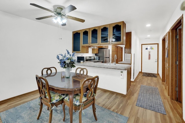 dining room featuring light wood-style flooring, recessed lighting, baseboards, and ceiling fan