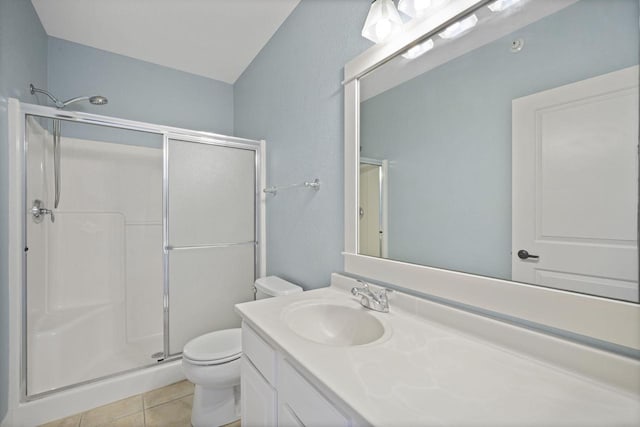 bathroom with tile patterned flooring, toilet, vanity, and a stall shower