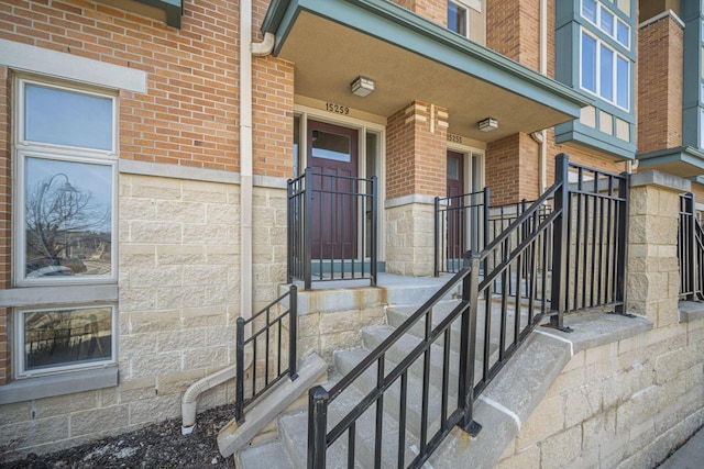 property entrance featuring brick siding