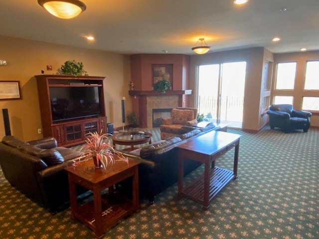 living room with recessed lighting, carpet floors, and a tile fireplace