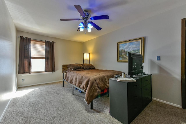 carpeted bedroom with baseboards and a ceiling fan