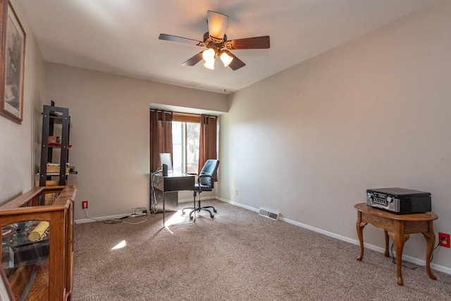 office area with visible vents, baseboards, a ceiling fan, and carpet floors