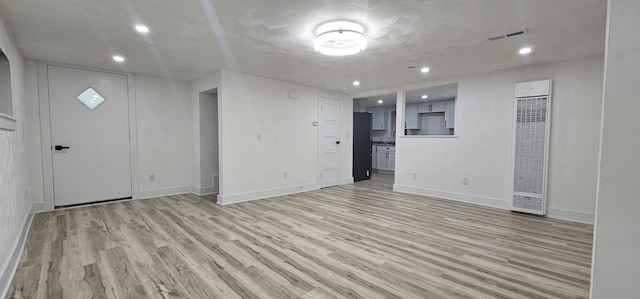 unfurnished living room with recessed lighting, visible vents, and light wood-style floors