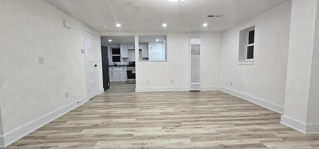 unfurnished living room featuring recessed lighting, visible vents, baseboards, and light wood finished floors