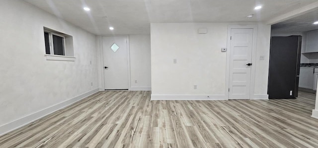 unfurnished room with recessed lighting, baseboards, and light wood-style floors