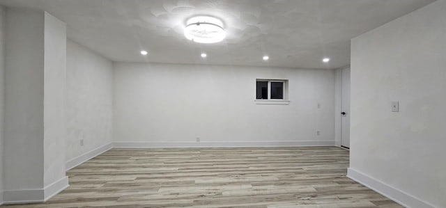 finished below grade area with recessed lighting, baseboards, and wood finished floors