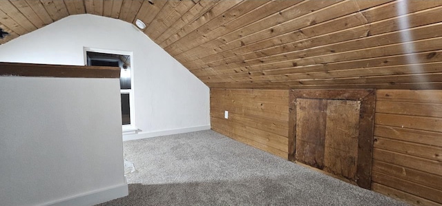 additional living space with lofted ceiling, carpet, wooden ceiling, and wood walls