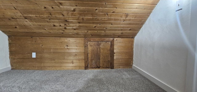 additional living space featuring wooden walls, wood ceiling, lofted ceiling, and carpet