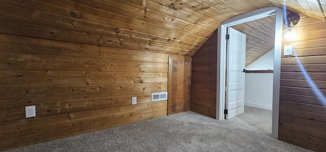 additional living space with visible vents, carpet, wood walls, wood ceiling, and vaulted ceiling