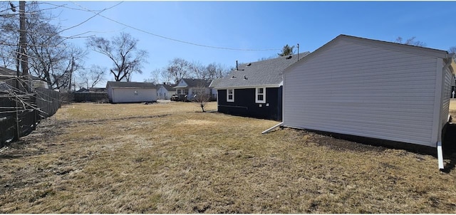 view of yard with an outdoor structure and fence