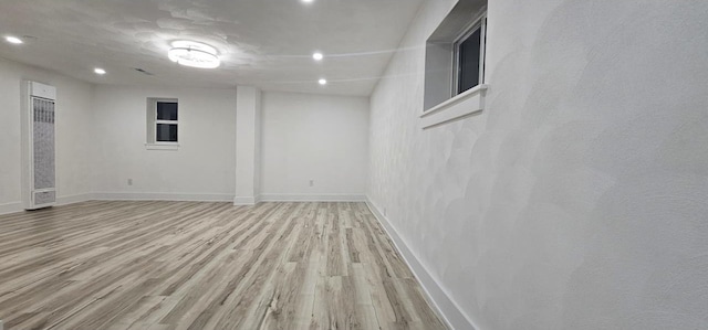 finished basement featuring recessed lighting, baseboards, and light wood finished floors