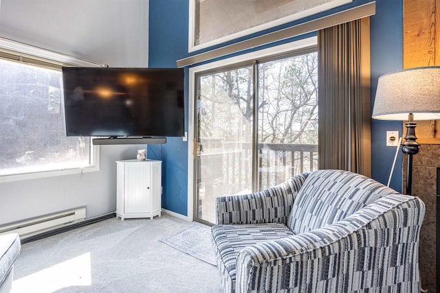 sitting room with carpet floors, a wealth of natural light, and a baseboard radiator