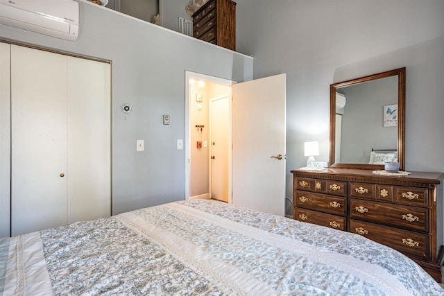 bedroom featuring a closet and a wall mounted AC