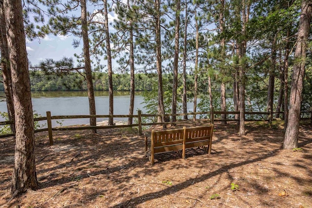 view of yard with fence and a water view