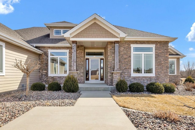 property entrance featuring a shingled roof