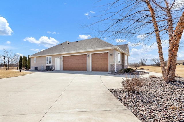 view of front of house with a garage, stone siding, driveway, and a shingled roof