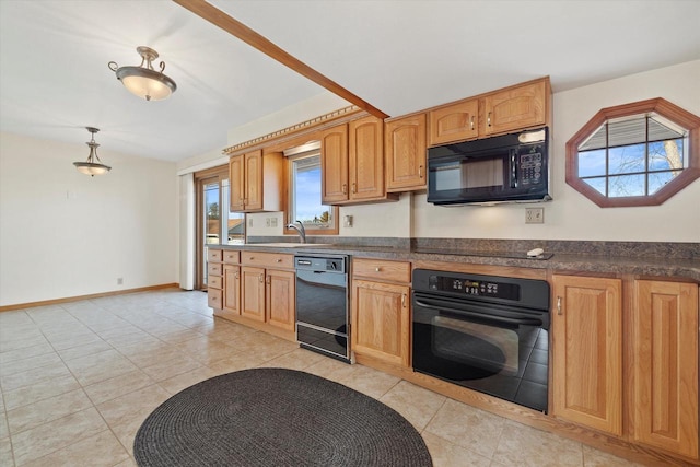 kitchen with dark countertops, black appliances, baseboards, and a sink