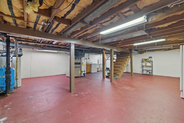 unfinished basement with washer / dryer, stairway, and gas water heater