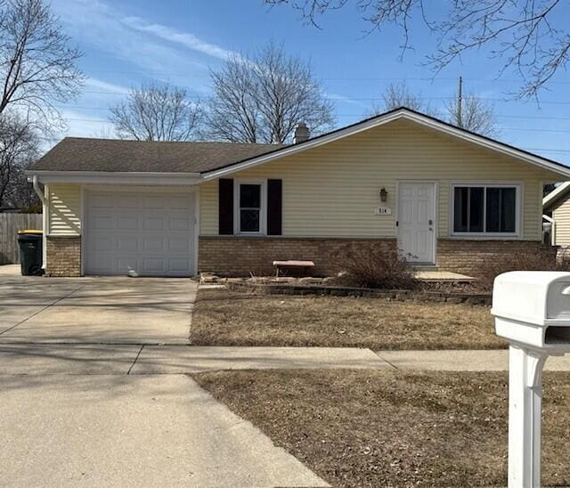 ranch-style house with brick siding, driveway, a garage, and fence