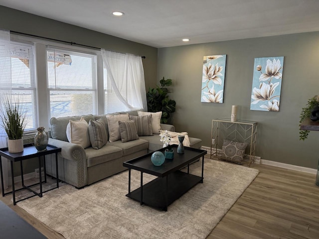 living area featuring recessed lighting, baseboards, and wood finished floors