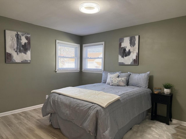 bedroom featuring light wood-type flooring and baseboards