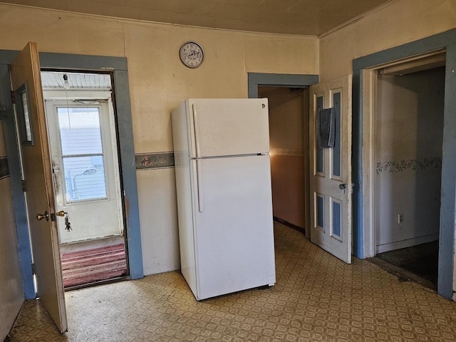 kitchen featuring tile patterned floors and freestanding refrigerator