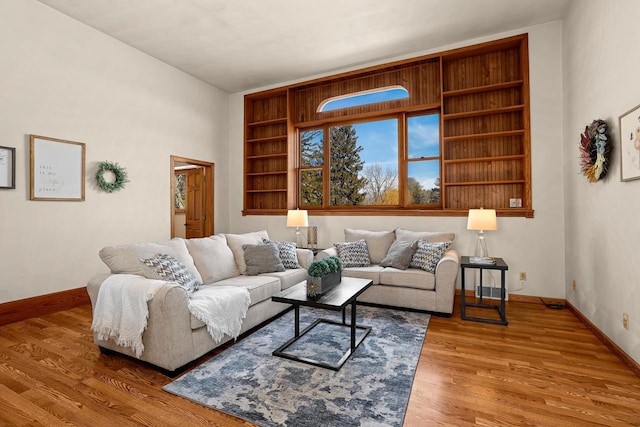 living area featuring baseboards and wood finished floors