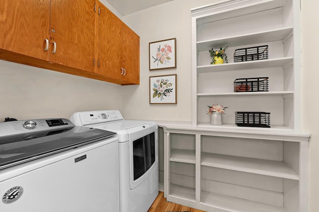 laundry area featuring cabinet space and separate washer and dryer