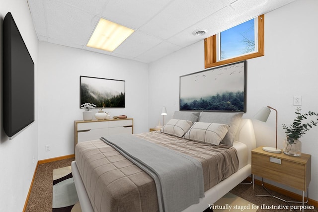 bedroom featuring a paneled ceiling, visible vents, carpet floors, and baseboards