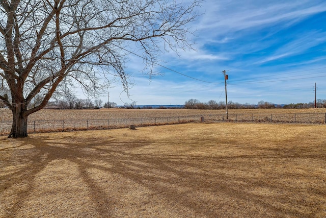 view of yard featuring a rural view and fence