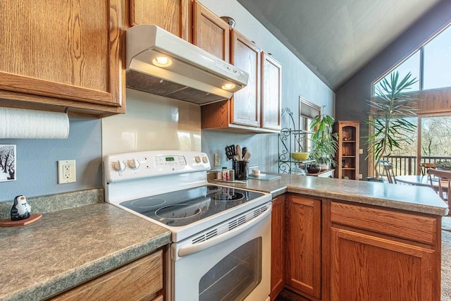 kitchen featuring brown cabinetry, a peninsula, vaulted ceiling, electric stove, and under cabinet range hood