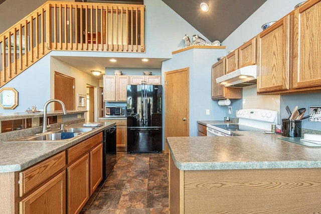 kitchen featuring under cabinet range hood, a peninsula, stone finish floor, black appliances, and a sink