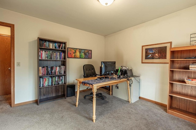 carpeted office featuring baseboards