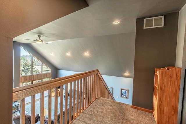 hall featuring carpet, visible vents, recessed lighting, vaulted ceiling, and an upstairs landing