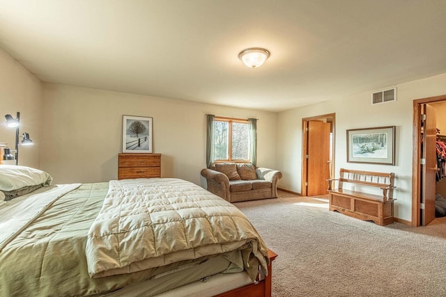 bedroom featuring visible vents, carpet floors, baseboards, and a spacious closet