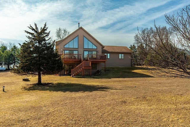 rear view of house with a deck, stairway, and a lawn