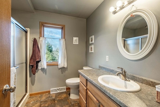 bathroom with visible vents, baseboards, vanity, and a shower stall