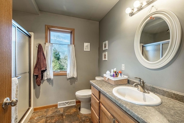 full bathroom featuring visible vents, baseboards, a stall shower, and vanity