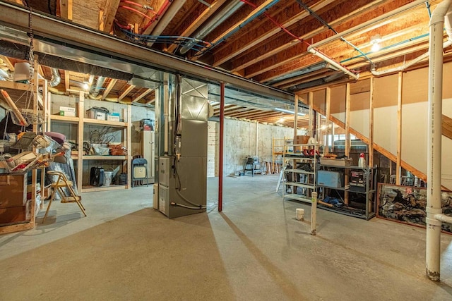 unfinished basement featuring heating unit