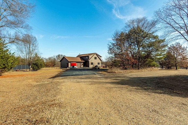 view of front of house with solar panels and driveway