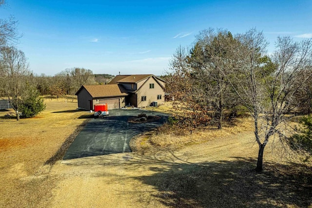 view of front facade featuring aphalt driveway and an attached garage