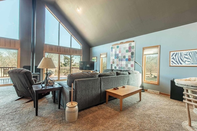 living area featuring baseboards, visible vents, carpet floors, and high vaulted ceiling