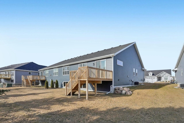 rear view of property featuring stairway, a residential view, central AC, and a deck