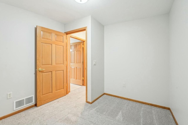 unfurnished bedroom featuring visible vents, baseboards, and carpet