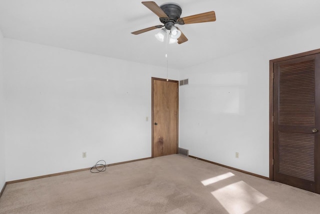 unfurnished bedroom featuring carpet flooring, baseboards, and visible vents