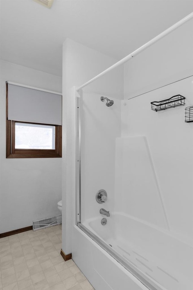 bathroom with visible vents, baseboards, toilet, bathing tub / shower combination, and tile patterned floors