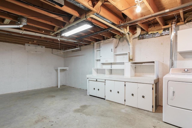 unfinished basement featuring washer / dryer