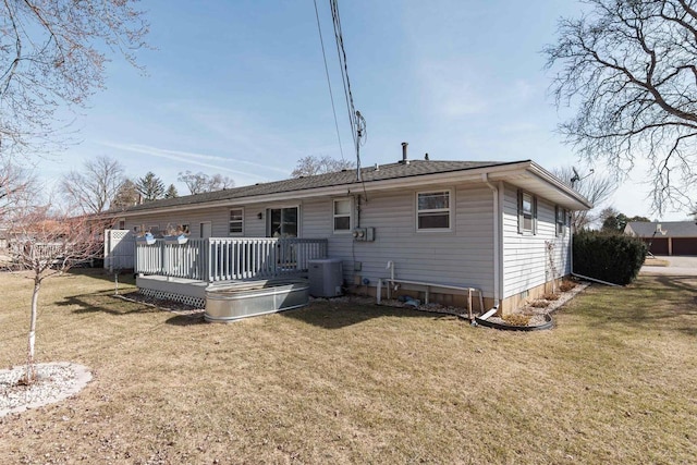 back of house with a shingled roof, a lawn, central AC, and a wooden deck